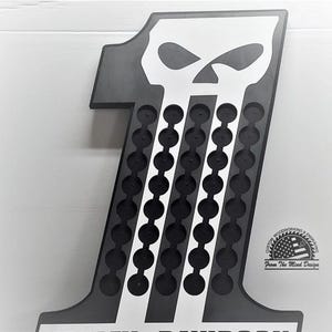 May include: A black and white wooden display in the shape of the number one, featuring a skull design at the top. The display has multiple circular cutouts. The text "HARLEY-DAVIDSON" is visible at the bottom. The product is from "From The Mind Design".