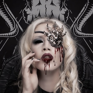 May include: A white ceramic mug with a black handle and the text "But first, coffee" in a black, handwritten-style font. The mug is on a white surface.