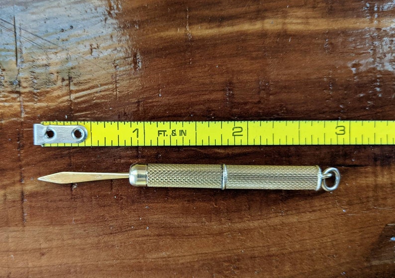 This rare 9K solid gold retractable toothpick—a unique and sophisticated blend of functionality and refinement. making a perfect gifts for luxury EDC (everyday carry) enthusiasts, or those who appreciate unconventional fine jewelry. This handcrafted piece merges discreet utility with old-world craftsmanship.  An unforgettable conversation starter for fans of unique gadgets, historical pocket accessories.