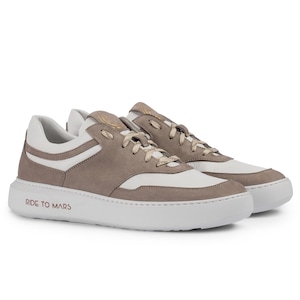 May include: A pair of low-top sneakers with a white and gray color scheme. The shoes have a suede upper and a white rubber sole. The text "RIDE TO MARS" is printed on the sole.