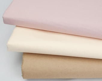 May include: Three sheets of tissue paper in different colors: pink, cream, and brown.