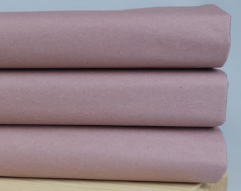 May include: Three folded pieces of dusty rose colored fabric. The fabric is smooth and has a subtle sheen.