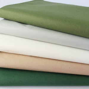 May include: Five sheets of tissue paper in different colors: green, gray, white, beige, and dark green.
