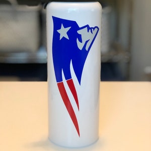 May include: White water bottle with a blue and red graphic design. The design features a blue shape with a white star and red accents. The bottle has a black and gray lid.