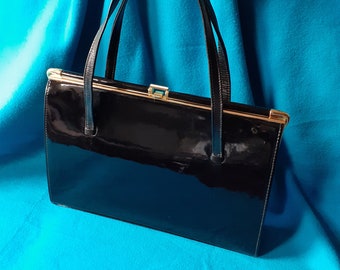 Black patent leather vintage 60s bag. Never been used, original 60s stock.