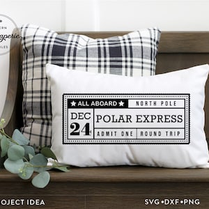 May include: A white pillow with a black and white ticket design that says "All Aboard North Pole Dec 24 Polar Express Admit One Round Trip".