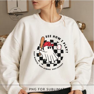 May include: White sweatshirt featuring a graphic of a ghost playing baseball with the text "See How I Play?" and "Very Mindful, Very Demure, Very Spooky" surrounding the graphic.