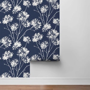 May include: A roll of navy blue wallpaper with a white floral pattern. The wallpaper has a repeating pattern of white flowers on a dark blue background.
