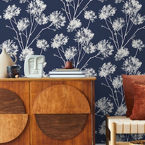 May include: A dark blue wallpaper with a white floral pattern. The wallpaper is in a living room with a wooden cabinet and a bench with a woven seat.