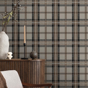 May include: A neutral-toned plaid wallpaper with a repeating pattern of gray, black, and brown lines. The wallpaper is displayed behind a wooden cabinet, a white chair, and decorative items, creating a cozy interior design scene.