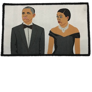 May include: Embroidered patch featuring a cartoon illustration of Barack and Michelle Obama in formal attire. Barack is wearing a black tuxedo with a bow tie and Michelle is wearing a black dress with a white necklace.