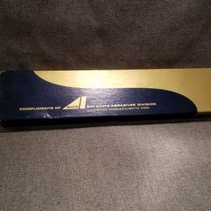 May include: A blue and gold box with the text "Compliments of AVCO Bay State Abrasives Division Westboro, Massachusetts 01581" printed on it.