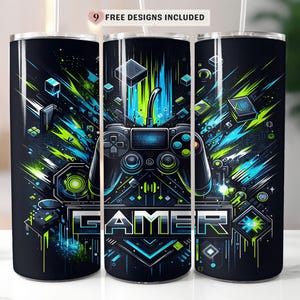 May include: A black tumbler with a vibrant design featuring a video game controller and the word "GAMER" in a futuristic font. The design incorporates blue and green geometric shapes and lines, creating a dynamic, tech-inspired aesthetic.