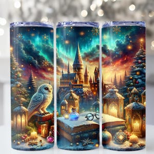 May include: A cylindrical tumbler with a fantasy-themed design. The artwork features a snowy castle, an owl, a Christmas tree, and lanterns under a colorful aurora borealis sky. The tumbler is decorated with snowflakes and other festive elements.