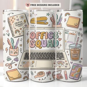 May include: A white tumbler featuring an office-themed design with the text "OFFICE SQUAD." The design includes a laptop, stationery, and the words "CREATIVE JOURNALS" and "COFFEE GANG." The tumbler has a straw and a lid.