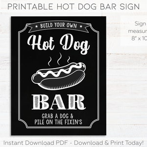 May include: Printable black and white sign with the text "Build Your Own Hot Dog Bar" and a graphic of a hot dog. The sign also says "Grab a dog & pile on the fixin's". The sign measures 8 inches by 10 inches.