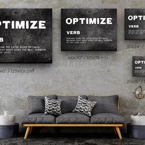 May include: Four black and white canvas prints with the word "OPTIMIZE" in large white letters. The word "VERB" is below the word "OPTIMIZE" in smaller white letters. The text below the word "VERB" explains the meaning of the word "OPTIMIZE". The prints are displayed on a gray wall with a gray couch in front of them. The prints are available in four different sizes: 50x40 inches, 40x30 inches, 30x24 inches, and 20x16 inches.