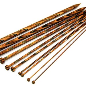 May include: A set of 10 wooden knitting needles in various sizes. The needles are made of a dark wood with a swirling grain pattern. The tips of the needles are pointed and the ends are rounded.