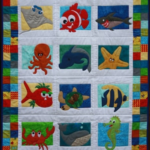 May include: A colourful quilt featuring a sea life theme. The quilt depicts a variety of sea creatures, including a stingray, a fish, an octopus, a dolphin, a starfish, a turtle, a seahorse, and a crab. The quilt is made with a variety of fabrics and colours, and is ideal for a child's room.