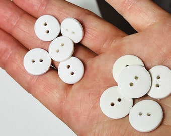 Pack of 10 buttons . Matt white in 2 sizes 15mm and 17mm . Dress blouse knitting and craft buttons . W11 W12 R110