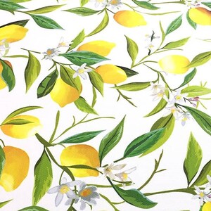 May include: A white background with a repeating pattern of yellow lemons and green leaves. The lemons are arranged in a random pattern and are surrounded by green leaves. The leaves are a darker shade of green than the lemons.