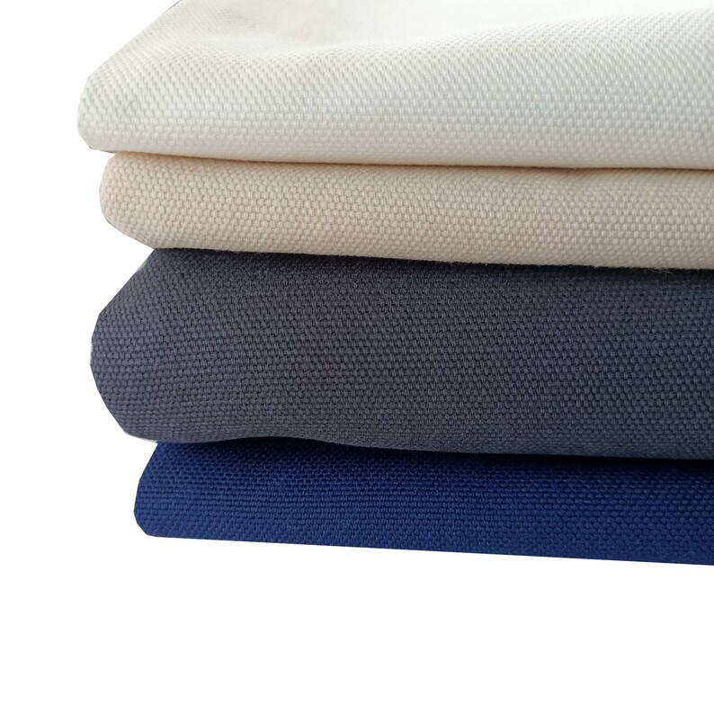 Puede incluir: Cuatro telas de diferentes colores apiladas una encima de la otra. La tela superior es blanca, la segunda tela es beige, la tercera tela es gris oscuro y la tela inferior es azul oscuro.