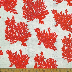 May include: Red coral branch pattern on a white linen fabric. The fabric is measured with a ruler in inches.
