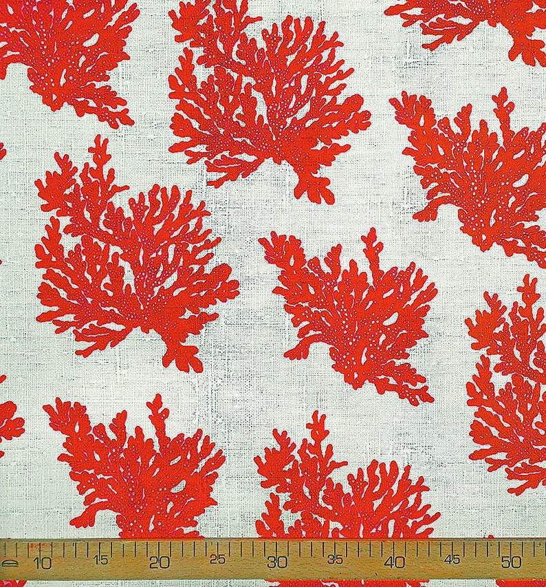 May include: Red coral branch pattern on a white linen fabric. The fabric is measured with a ruler in inches.