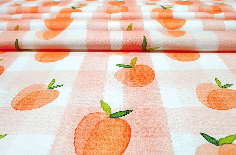 May include: Peach print fabric with a white and pink gingham pattern. The fabric is folded in half and the peaches are watercolour style.