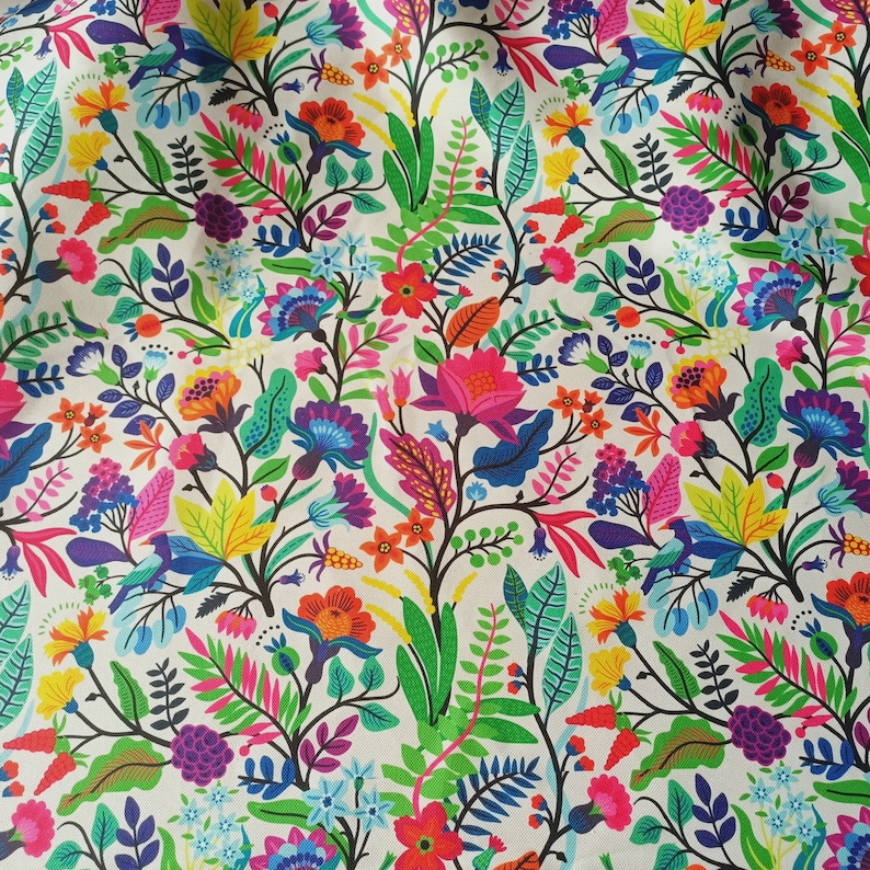 May include: A vibrant floral fabric featuring a dense pattern of colorful flowers, leaves, and berries in shades of pink, blue, yellow, and green against a white background. The design includes stylized birds and intricate botanical details.
