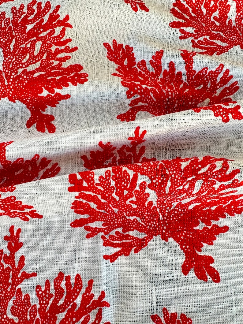 May include: White fabric with a repeating pattern of red coral branches.