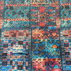 May include: A colorful fabric with a patchwork design featuring various geometric patterns in shades of blue, red, orange, and white.