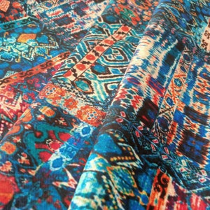 May include: Close-up of a colorful fabric with a geometric pattern in shades of blue, red, orange, and white.