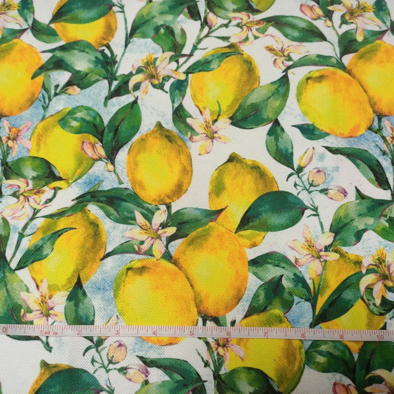 May include: White fabric with a repeating pattern of yellow lemons and green leaves. The lemons are painted in a watercolor style and have a realistic appearance.