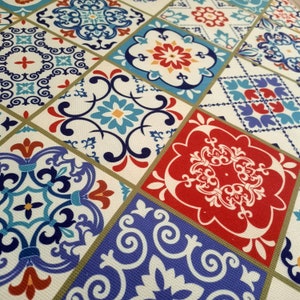May include: A colorful patterned fabric with a repeating design of blue, red, and white tiles. The tiles feature intricate floral and geometric patterns.
