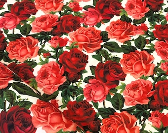 May include: A white fabric with a repeating pattern of red and pink roses. The roses are in full bloom and have a realistic appearance.