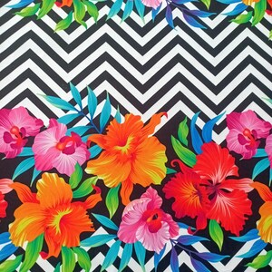 May include: A black and white chevron pattern fabric with a colorful floral print. The flowers are pink, orange, red, and yellow. The fabric is perfect for crafting projects, quilting, and home decor.