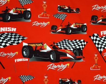 May include: Red fabric with a repeating pattern of checkered flags, race cars, and the word "Racing" in a stylized font. The cars are black and red with the number 8 on the side. There are also images of a trophy and a person standing on a podium.