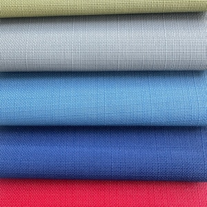 May include: A stack of six fabric swatches in different colours. The swatches are arranged from top to bottom: light green, light grey, light blue, dark blue, red, and black.