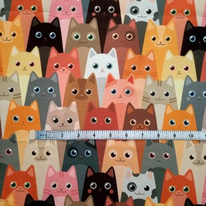 May include: A colorful fabric with a repeating pattern of cartoon cats. The cats are in various colors and poses, including orange, pink, gray, brown, and black. The fabric is perfect for crafting projects, such as making bags, pillows, or quilts.