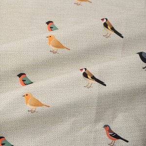 May include: A beige fabric with a repeating pattern of colorful birds. The birds are in various poses, including flying, perched, and singing. The fabric has a subtle texture.