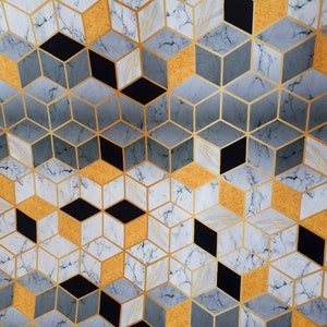 May include: Geometric pattern fabric featuring a repeating cube design. The cubes are in shades of gray, gold, black, and white with a marble-like texture. Gold lines outline the cubes, creating a modern, abstract design.