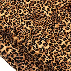 May include: Brown and black leopard print fabric with a soft, fuzzy texture.