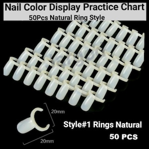 May include: Fifty white plastic nail display rings in a natural ring style. The rings are arranged in rows and are 20 mm in size. The text "Style#1 Rings Natural 50 PCS" is printed on the bottom of the image.