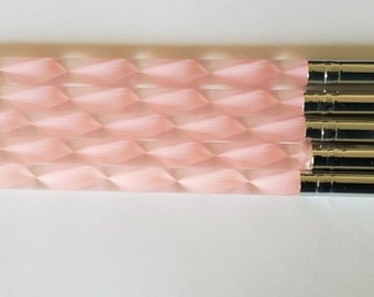 May include: Set of five nail art tools with pink handles and white silicone tips. The tools have a silver metal shaft and are arranged in a row.