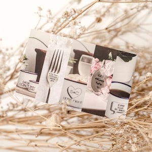 May include: A collage of images featuring personalized mugs, spoons, and bowls with various engraved messages. The mugs feature the text "Day 2 Day" and "Coda & Baby", the spoons feature the text "Make the rest of the world wait for you" and "Fall asleep here", and the bowl features the text "S&C date night".