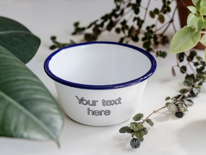 May include: White enamel bowl with a blue rim. The bowl has the text "Your text here" printed on the front.