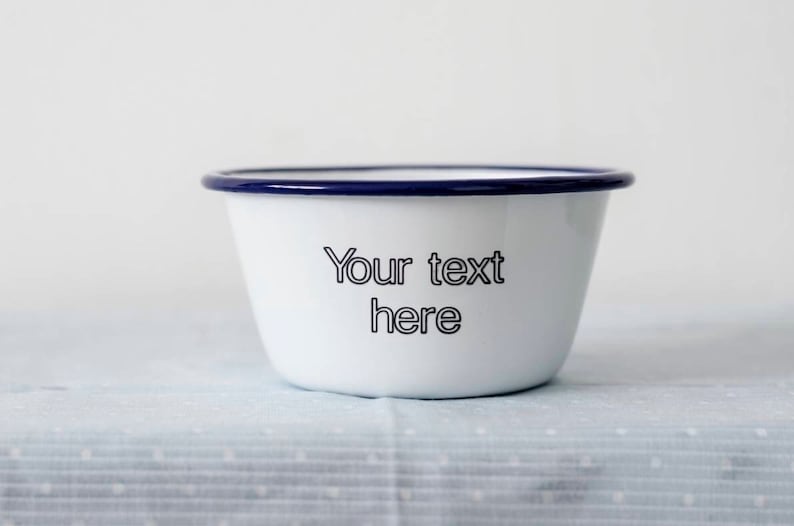 May include: White enamel bowl with a blue rim. The bowl has the text "Your text here" printed on the front.