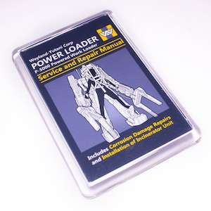 May include: A black and yellow magnet with a white illustration of a robot and the text "Weyland-Yutani Corp POWER LOADER P-5000 Powered Work Loader Service and Repair Manual Includes Corrosion Damage Repairs and Installation of Incinerator Unit"