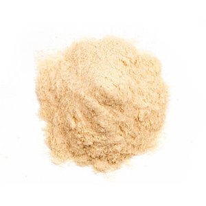 May include: A close-up of a pile of light brown powder on a white background.
